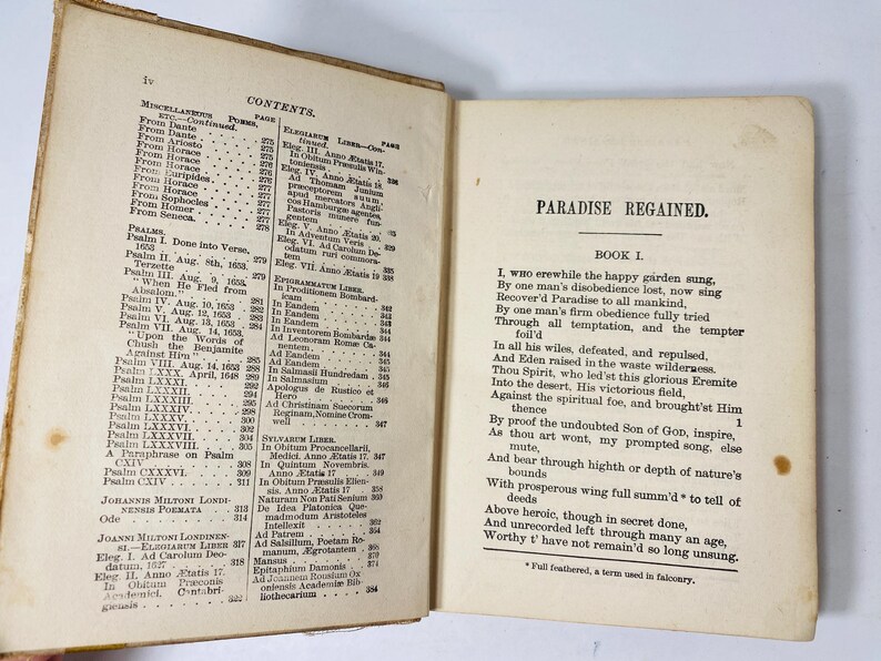May include: Open antique book with aged, yellowed pages. The left page displays a detailed table of contents, while the right page features the title "PARADISE REGAINED" and the beginning of a poem. The book is open, showing the text.