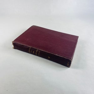May include: A burgundy hardback book with the title "The Adventures of Sherlock Holmes" printed on the spine.