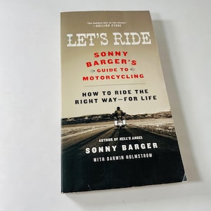 May include: A book titled "Let's Ride" by Sonny Barger, with the subtitle "Sonny Barger's Guide to Motorcycling." The cover features a motorcycle on a road and the text "How to Ride the Right Way-For Life."