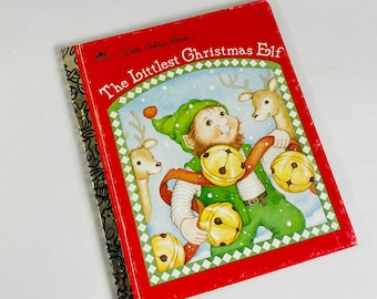 May include: A Little Golden Book titled "The Littlest Christmas Elf" with a red cover featuring an illustration of a smiling elf wearing a green hat and holding jingle bells, with two deer in the background.