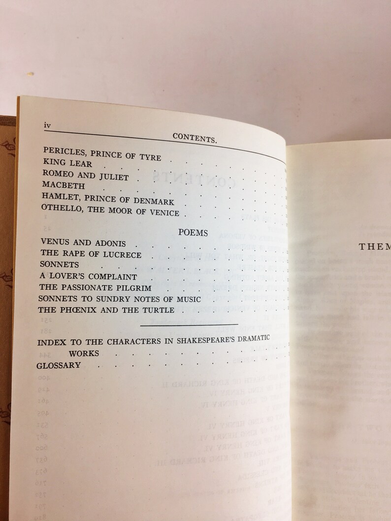 May include: Open book displaying a table of contents. The contents include titles of Shakespeare's plays and poems, such as "Romeo and Juliet" and "Venus and Adonis." The page is cream-colored with black text.