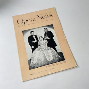 May include: A vintage Opera News magazine cover from January 12, 1945, featuring a black and white photo of a woman in a gown with two men in suits. The text on the cover reads "Opera News" and "Traviata Today by Ken C. Baumann".