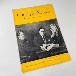 May include: A yellow magazine cover with the title "Opera News" printed in black. The cover features a black and white photo of three men sitting at a table. The text below the photo reads "The Reality of Wagner's Imagination by Lee Simonson".