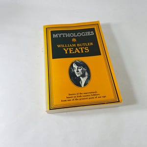 May include: A yellow hardback book titled "Mythologies" by William Butler Yeats. The cover features black text and a portrait. The book's description is on the bottom. The book is a collection of stories.