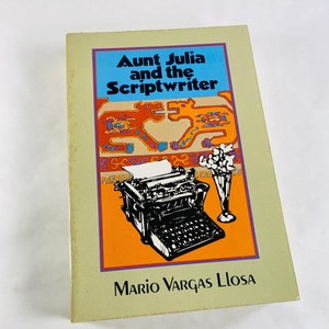 May include: A book cover with a colorful illustration of a typewriter and a patterned rug. The title is "Aunt Julia and the Scriptwriter" by Mario Vargas Llosa.