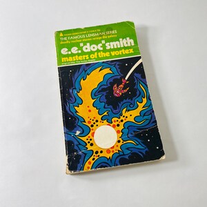 May include: A vintage paperback science fiction book titled Masters of the Vortex by E.E. Doc Smith. The cover features a vibrant illustration of a yellow and blue cosmic vortex against a black space background with a small red spaceship.