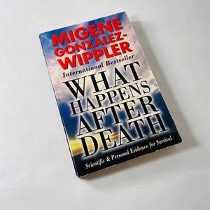 May include: A book titled "What Happens After Death" by Migene Gonzalez-Wippler. The book is a paperback with a blue cover and white text. The subtitle is "Scientific & Personal Evidence for Survival".