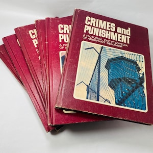 May include: A stack of red hardback books with the title "Crimes and Punishment: A Pictorial Encyclopedia of Aberrant Behaviour" on the top book.