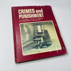 May include: A red hardback book titled "Crimes and Punishment: A Pictorial Encyclopedia of Aberrant Behaviour". The cover features a black and white photograph of an electric chair.
