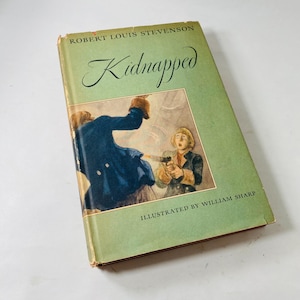 May include: A vintage copy of "Kidnapped" by Robert Louis Stevenson. The book has a green cover with the title in elegant script. The cover illustration depicts a scene with two figures, one aiming a gun. Illustrated by William Sharp.