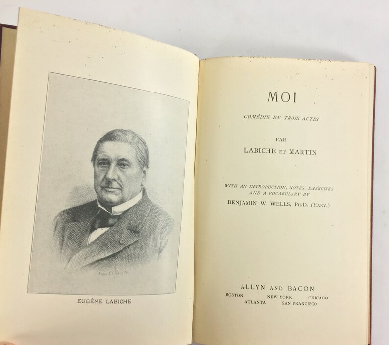 May include: A black and white portrait of Eug&egrave;ne Labiche, a French playwright, with the title "MOI" and the text "COM&Eacute;DIE EN TROIS ACTES" above it. The text "PAR LABICHE ET MARTIN" is below the title. The text "WITH AN INTRODUCTION, NOTES, EXERCISES AND A VOCABULARY BY BENJAMIN W. WELLS, PH.D. (HARV.)" is below the author's names. The text "ALLYN AND BACON" is at the bottom of the page, with the cities "BOSTON, ATLANTA, NEW YORK, CHICAGO, SAN FRANCISCO" listed below.