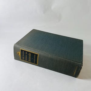 May include: A hardcover book titled "The Basic Works of Aristotle" with a teal cover and gold lettering. The book is a vintage edition, likely from the mid-20th century, and is in good condition. The spine features the title and author's name.