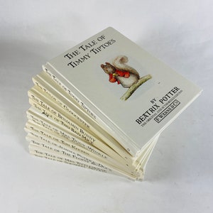 May include: A stack of ten Beatrix Potter children's books, featuring the original and authorized edition of "The Tale of Timmy Tiptoes". The books are arranged with the spines facing out, and the top book is "The Tale of Timmy Tiptoes".