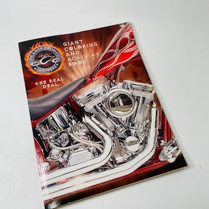 May include: A coloring and activity book featuring a motorcycle engine and the text "Orange County Choppers". The cover has a red and black design with chrome engine components. The book is titled "Giant Coloring and Activity Book".
