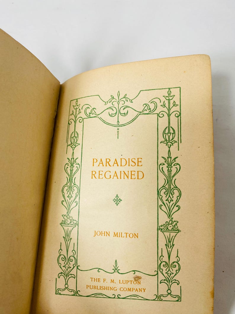 May include: Open book with the title "Paradise Regained" in gold lettering. The book's cover features a green decorative border and the author's name, John Milton. Published by The F. M. Lupton Publishing Company.