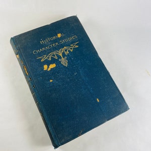 May include: A blue hardcover book with the title "Historical Character Studies" in gold lettering on the front cover.