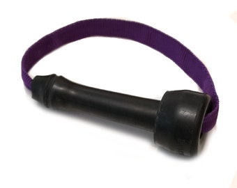 May include: A black rubber dumbbell-shaped exercise tool with a purple fabric loop handle. The dumbbell has a cylindrical centre and flared ends. The purple handle is a continuous loop attached to the dumbbell.