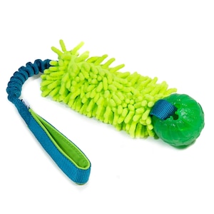 May include: A dog toy featuring a bright green, textured, rectangular body with a matching green ball at one end. A blue elastic cord and handle are attached. The toy is designed for interactive play and exercise.