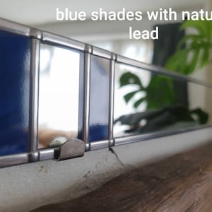 May include: A handmade, wooden serving tray with a natural finish. The tray features a rectangular shape with rounded corners and two handles. The wood grain is visible, adding to its rustic charm. Dimensions: 18 inches long, 12 inches wide, and 2 inches high.