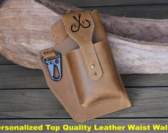 May include: A brown leather waist wallet with a large pocket and a smaller pocket for a phone. The wallet has a belt loop and a clip. The wallet is personalized with the initials "K.F." and two crossed fishing hooks.