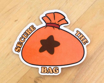 May include: A die-cut sticker featuring an orange money bag with a dark brown star symbol on the front. The bag is tied at the top with a red band. The text SECURE THE BAG is printed in bold, light-colored letters around the central orange pouch.