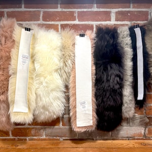 May include: A white ceramic mug with a black handle and the text "But First, Coffee" in a black, bold font. The mug is on a white surface. The mug is approximately 4 inches tall.