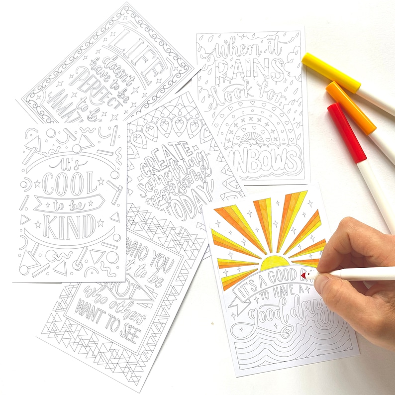 May include: Five printable colouring cards with positive messages. The cards feature black and white illustrations with motivational quotes like "It's cool to be kind" and "When it rains look for rainbows".