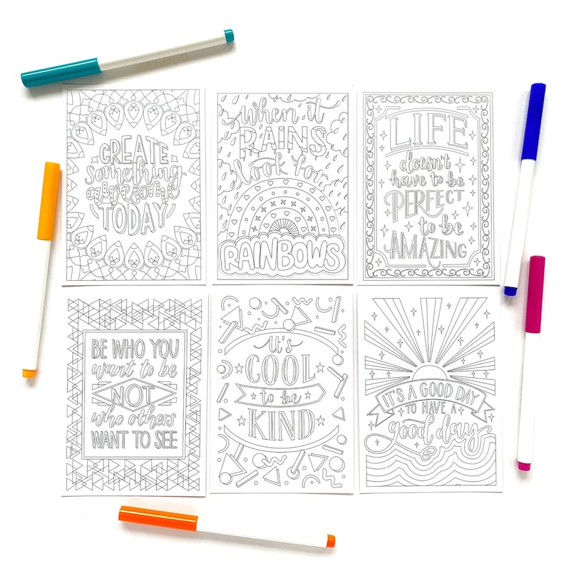 May include: Six printable colouring cards with positive messages and illustrations. The cards feature phrases like "Create something amazing today", "When it rains look for rainbows", "Life doesn't have to be perfect to be amazing", "Be who you want to be not who others want to see", "It's cool to be kind", and "It's a good day to have a good day".