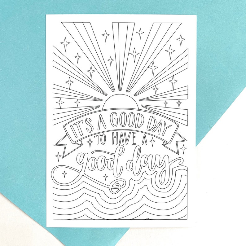 May include: Black and white colouring page featuring a sun, stars, and waves. The text reads "It's a good day to have a good day."