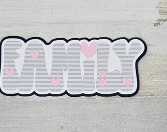May include: A gray and white striped word "FAMILY" with pink hearts. The word is outlined in black.