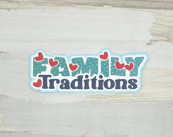 May include: A sticker with the words "FAMILY Traditions" in a playful font. The word "FAMILY" is in teal with white polka dots and red hearts. The word "Traditions" is in navy blue. The sticker has a light blue border.