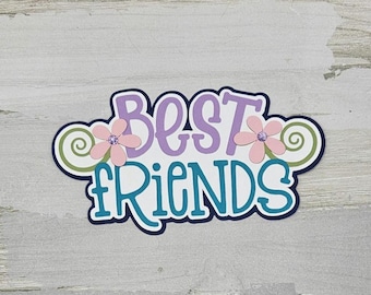 May include: A purple and teal paper craft with the words "Best Friends" and two pink flowers with green swirls.