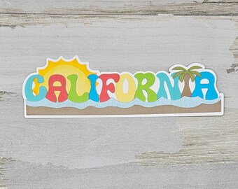 May include: A colorful sticker with the word "CALIFORNIA" in a retro font. The sticker features a yellow sun, blue waves, and a green palm tree.