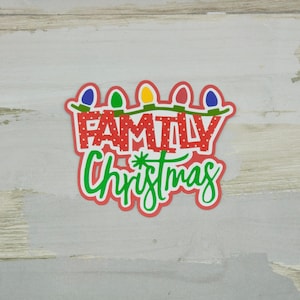 May include: Red and green Christmas decoration with white polka dots and the text "FAMILY Christmas" with a string of colorful lights above the text.