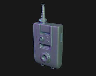 May include: A gray, rectangular device with a black antenna, a round lens, and several buttons. The device has a textured surface and a slightly rounded shape.