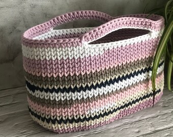 A large beach bag, an oval colorful hand basket.