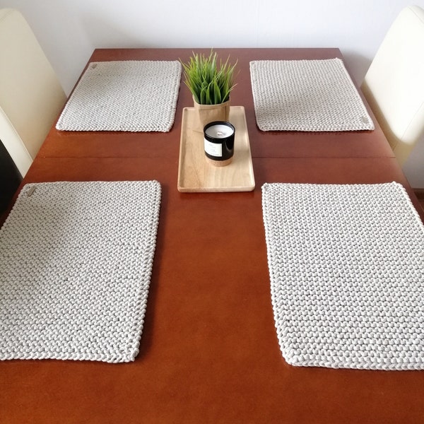 Set de table sur la table, sous l'assiette, rectangulaire.