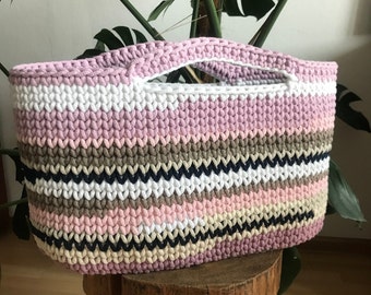 A large beach bag, an oval colorful hand basket.