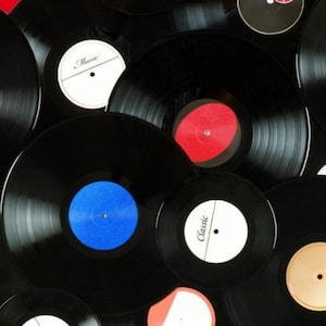 May include: A collection of vintage vinyl records with various labels and colors. The records are stacked on top of each other, creating a visually appealing display.