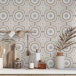 May include: A kitchen countertop with a patterned wallpaper featuring a geometric design in shades of beige and grey. The countertop has a variety of kitchen items, including mugs, wooden chopping boards, utensils, and a jar of spices.