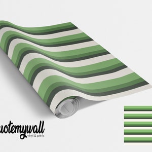 May include: A roll of green and white striped wallpaper with a sample of the pattern shown on the right. The wallpaper is from the company "quotemywall vinyl & prints".