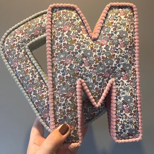 betsy ann fabric.
C in with a mint corduroy trim and the M is with a dusty pink corduroy trim.