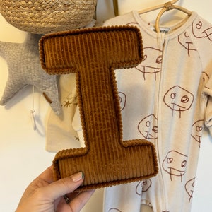 letter I in rust corduroy.