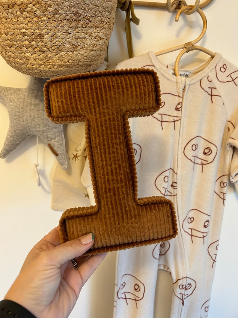 letter I in rust corduroy.