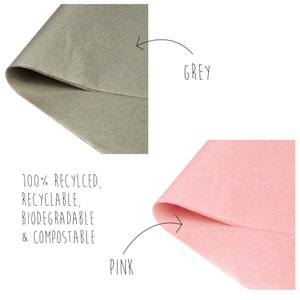 May include: Two sheets of tissue paper, one grey and one pink. The tissue paper is 100% recycled, recyclable, biodegradable, and compostable.