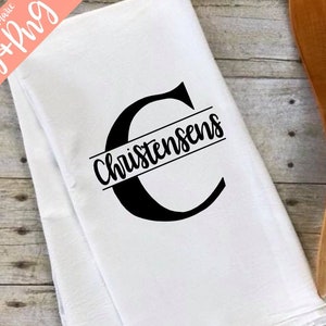 May include: White kitchen towel with a black letter C and the name "Christensen" printed across the center.