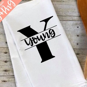 May include: White kitchen towel with a black letter Y and the word "young" printed on it.