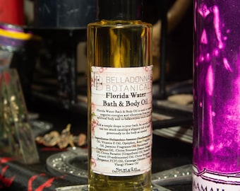 Pode incluir: Uma garrafa de vidro transparente de óleo para banho e corpo Florida Water com tampa preta. O rótulo diz "BELLADONNA BOTANICALS" e lista os ingredientes. A garrafa contém um líquido amarelo e tem 118 ml.