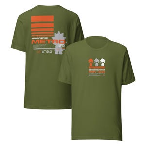 May include: Two olive green t-shirts. One shirt features orange and white text and graphics that read "GOOGIVERSE METRO MECH" and "od v 2.0". The other shirt has three robot figures and the text "GOOGIVERSE MECH SYSTEM MK-02 TYPE ONE TECH EDITION."