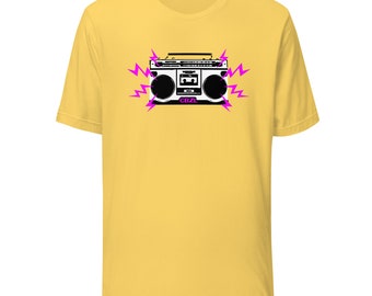 May include: A yellow t-shirt with a black and white illustration of a boombox with pink lightning bolts. The boombox has the text "CBZL" on it.